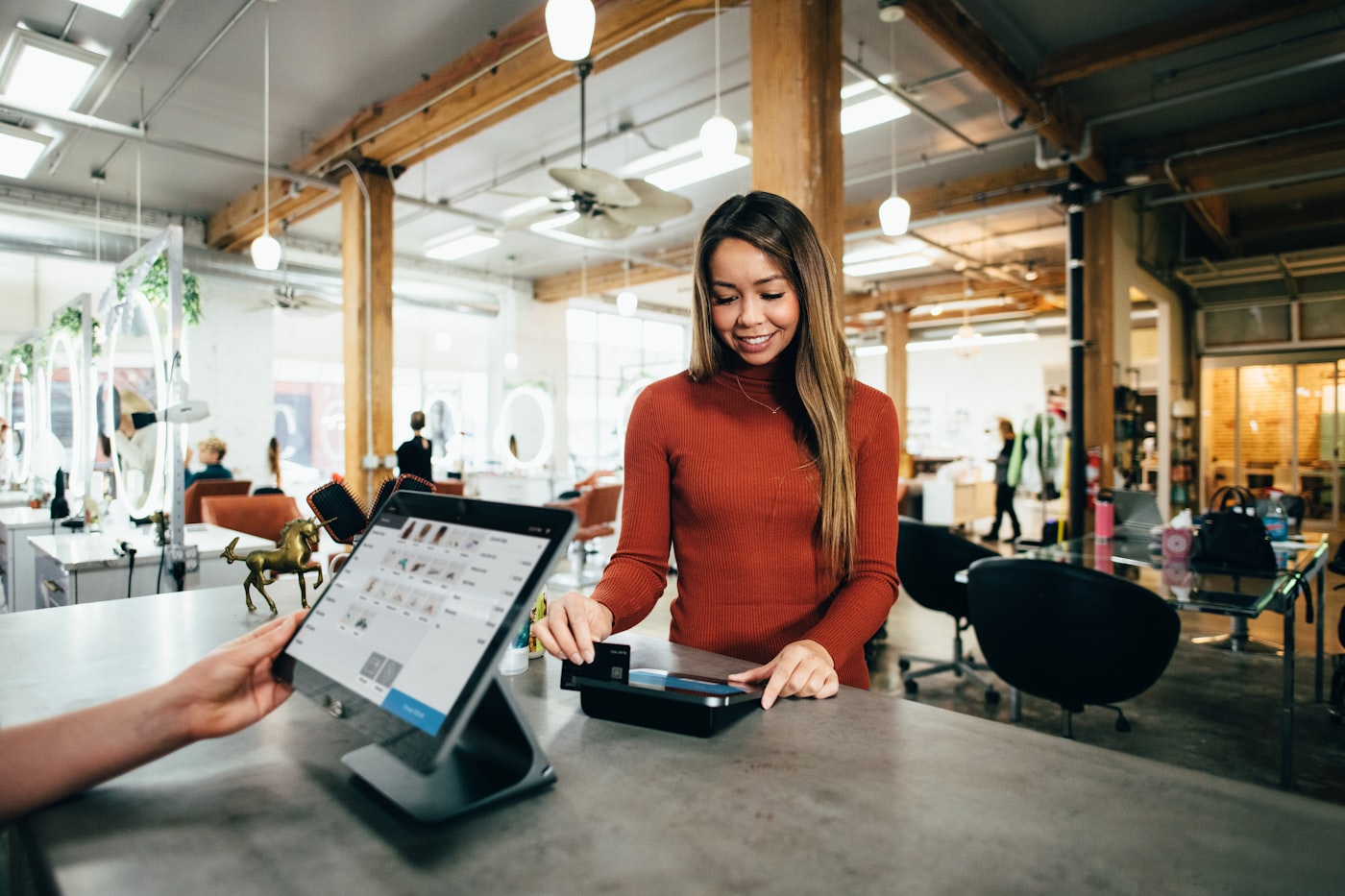 Shop staff taking a card payment on a tablet POS system